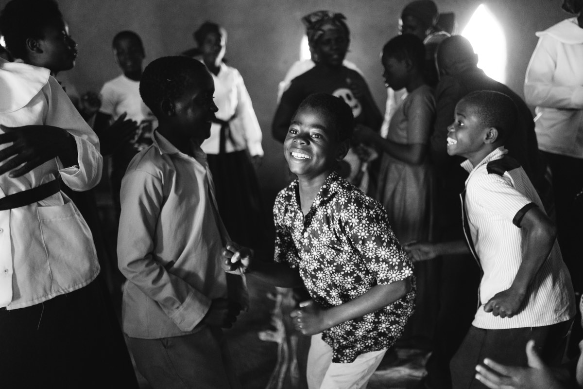 Young people dancing and celebrating inside a church