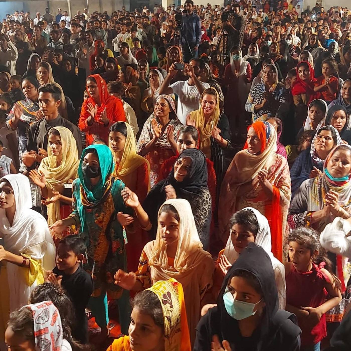 Women and children crowded together at a meeting in Pakistan
