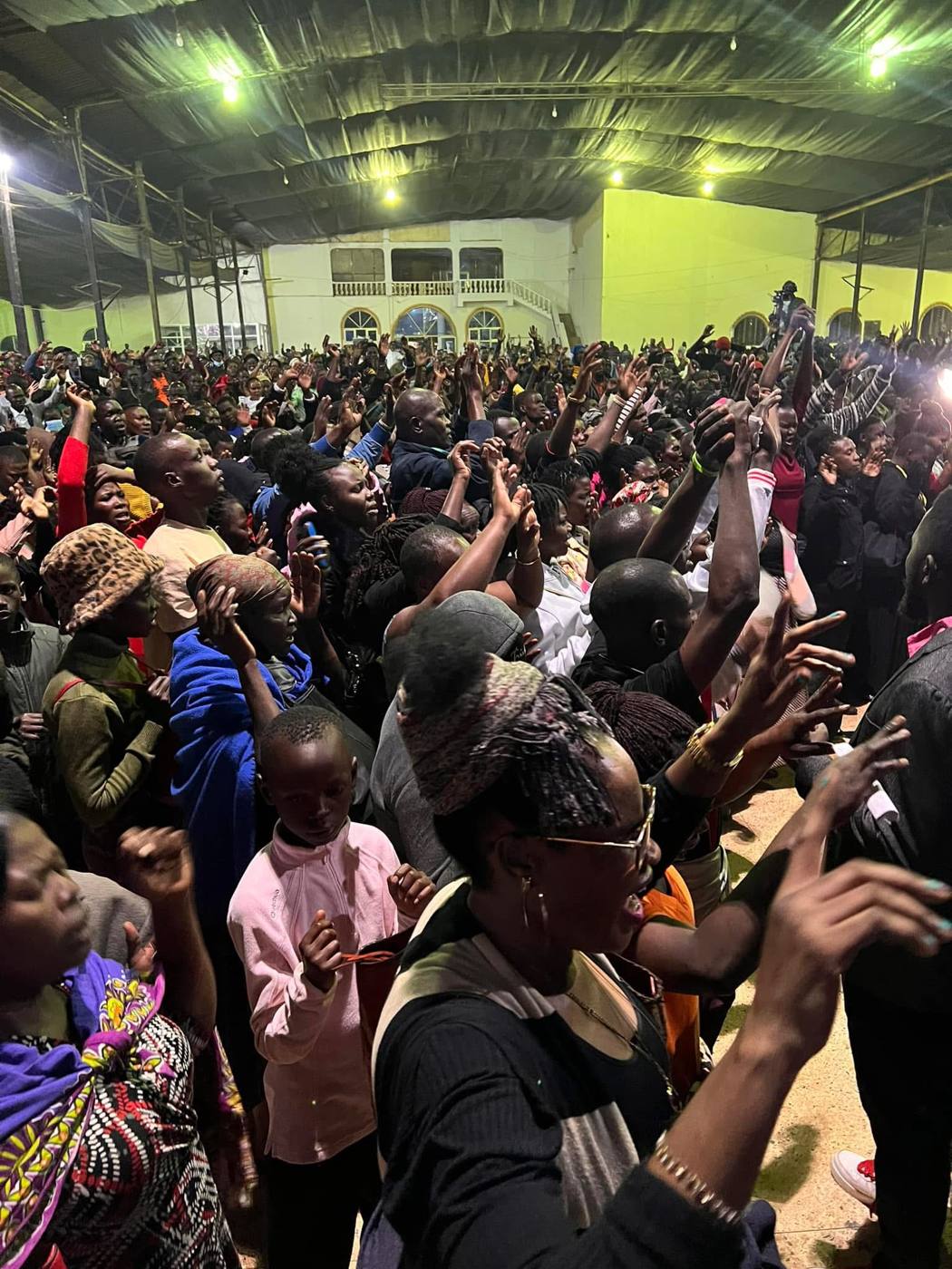 A packed hall worshipping in Uganda