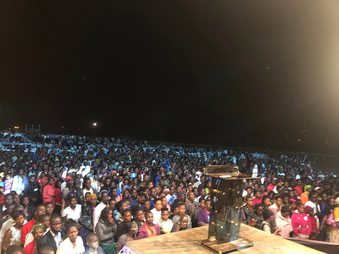 A vast crowd gathered at night for an outdoor crusade in Uganda