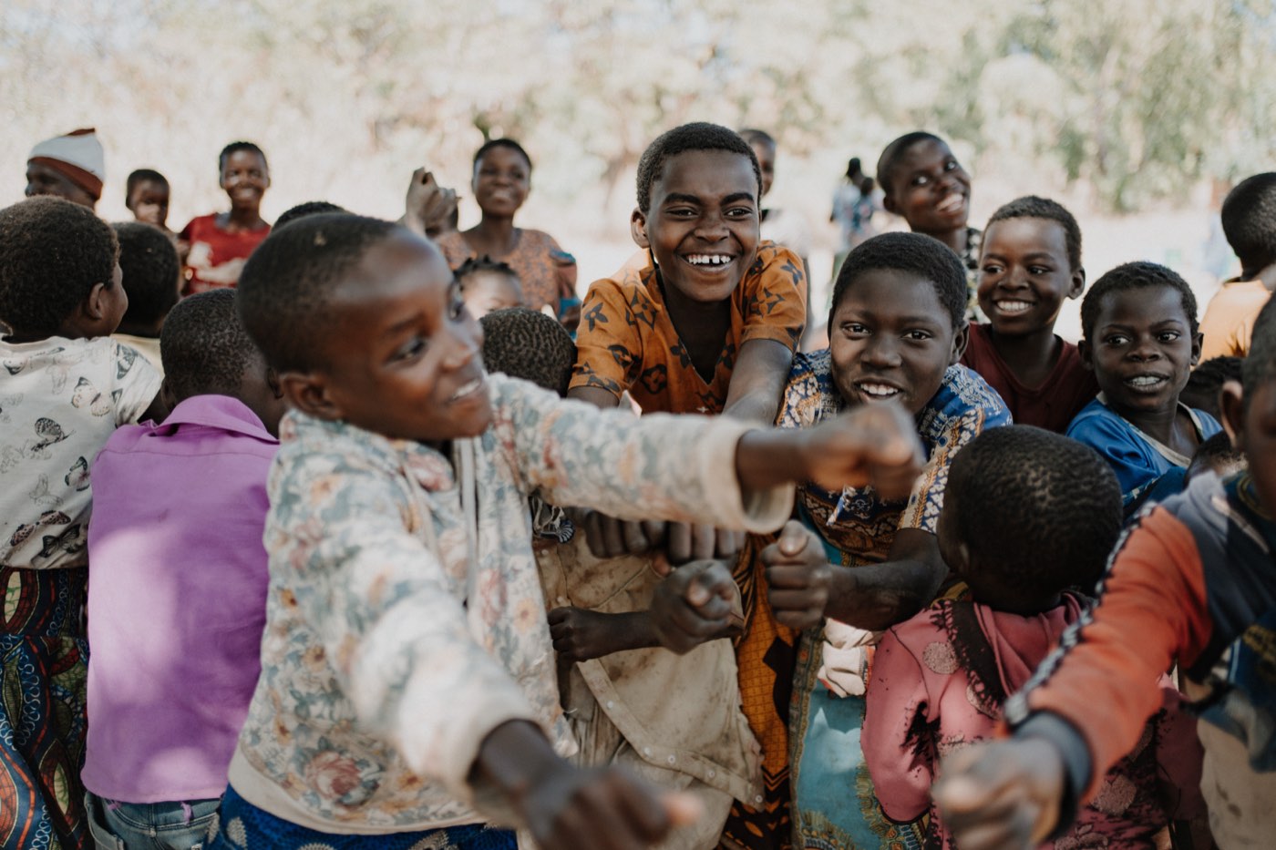 Children laughing together with arms around each other